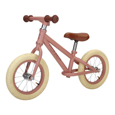 balance bike pink with tan handles and sadle and white wheels from Little dutch